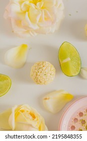 White Chocolate Candies And Lemon Slices On White Background. Food Styling. Spring And Summer Comfort Food.