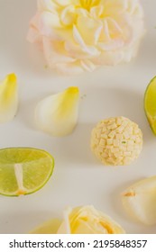 White Chocolate Candies And Lemon Slices On White Background. Food Styling. Spring And Summer Comfort Food.