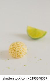 White Chocolate Candies And Lemon Slices On White Background. Food Styling. Spring And Summer Comfort Food.