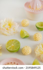 White Chocolate Candies And Lemon Slices On White Background. Food Styling. Spring And Summer Comfort Food.