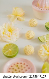 White Chocolate Candies And Lemon Slices On White Background. Food Styling. Spring And Summer Comfort Food.