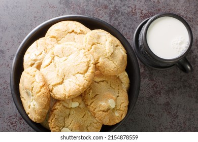 White Chocolate Caramel Soft And Macadamia Nuts Baked Cookies Served With Cup Of Milk On The Table Close-up. Horizontal Top View From Above
