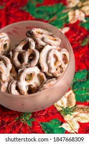 White Chocolate Coated Pretzels In Bowl On Christmas Table Runner