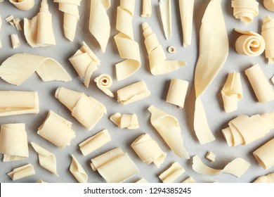 White Chocolate Curls On Gray Background, Top View