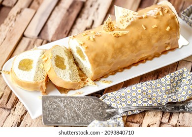 White chocolate, hazelnut, apple and caramel log on wooden table - Shutterstock ID 2093840710