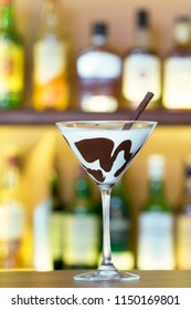 White Chocolate Martini Garnish With A Black Chocolate Stick On Bar Desk