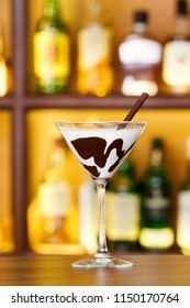 White Chocolate Martini Garnish With A Black Chocolate Stick On Bar Counter