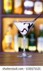 White Chocolate Martini Glass Garnish With A Black Chocolate Stick On Bar