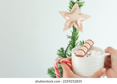 White chocolate on hot chocolate cup with candy cane. - Powered by Shutterstock