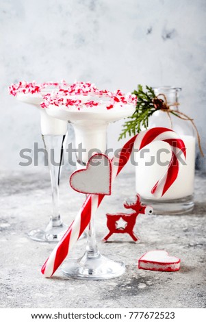 White chocolate peppermint martini with candy cane rim. Christmas holiday party drink idea