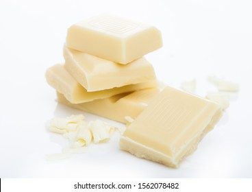 White chocolate pieces and curls isolated on white.