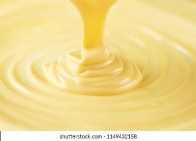 White Chocolate. Pouring Melted Liquid Premium Milk White Chocolate. Close Up Of Molten Liquid Hot Chocolate Swirl. Confectionery. Confectioner Prepares Dessert, Icing