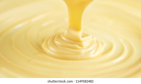 White Chocolate. Pouring Melted Liquid Premium Milk White Chocolate. Close Up Of Molten Liquid Hot Chocolate Swirl. Confectionery. Confectioner Prepares Dessert, Icing