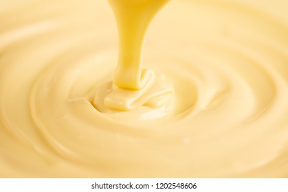 White Chocolate. Pouring Melted Liquid Premium Milk White Chocolate. Close Up Of Molten Liquid Hot Chocolate Swirl. Confectionery. Confectioner Prepares Dessert, Icing