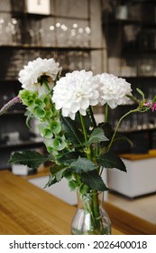 White Chrysanthemum Flowers Bouquet In Glass Vase On The Table Close Up.