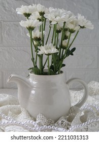 White Chrysanthemum In A White Teapot Vase