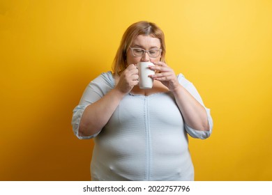 White And Chubby Young Woman Drinking Cup Of Coffee. Overweight Person