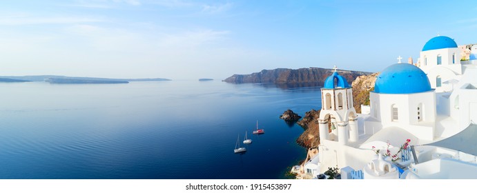 white church belfry, blue domes and volcano caldera with sea landscape, beautiful details of Santorini island, Greece, web banner format
