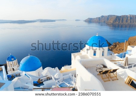 white church belfry, brigh blue domes and volcano caldera with sea landscape, beautiful details of Santorini island, Greece