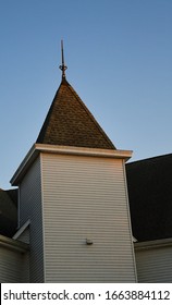 White Church Steeple With A Shingled Roof