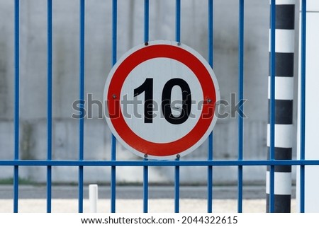white circle road sign with red border and number ten. speed limit 10 kilometers per hour. High quality photo
