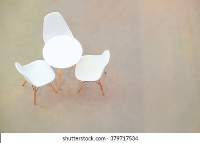 White Circle Table And Chairs On Carpet Floor. View From Above