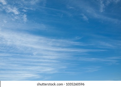 White Cirrus Clouds On The Blue Sky