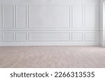 White classic wall background, brown parquet floor, home furniture detail, frame and vase of plant.