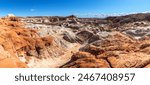 White clay-like sediment coming from nearby Gunsight Butte covers much of the red sandstone at Utah