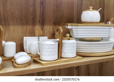 White Clean China Dishes On A Wooden Shelf. Department Of Crockery, Household Goods. Kitchen Interior Design