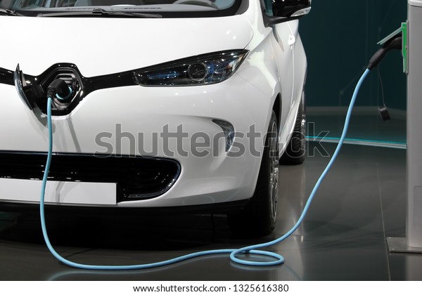 White and\
clean electric car charging in a garage.\
