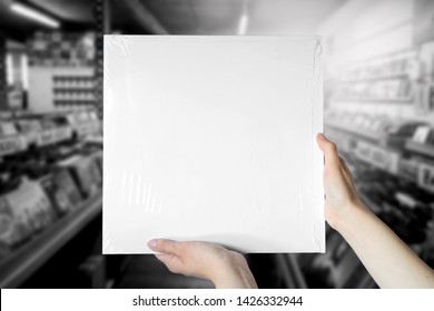 White Clean Vinyl Cover Mockup Holding In Hands In Music Store Background