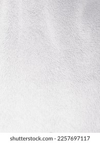 White clean wool texture background. light natural sheep wool. white seamless cotton. texture of fluffy fur for designers. close-up fragment white wool carpet.	