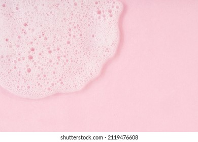 White Cleanser Foam Drop On Pink Background. Soap, Shower Gel, Shampoo Foam Texture Closeup