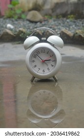 a white clock, with a classic model