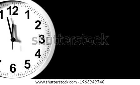 White clock face of a Wall Clock show the time. It's almost 12 o'clock. The latest report of the atomic scientist shows the doomsday clock 100 seconds to twelve.  Time is running out for mankind.