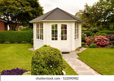 White Closed Gazebo In Garden In Summer