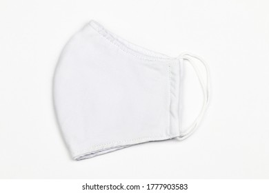 A White Cloth Mask And An Elastic Band To Fasten The Ears And The White Background.