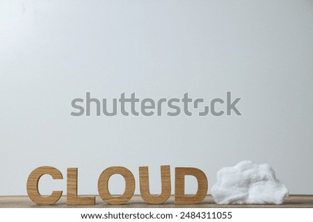 A white cloud made of cotton wool near the word 
