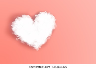 White cloud in the shape of a heart with soft shadow against pink color background. Concept of love and feelings.