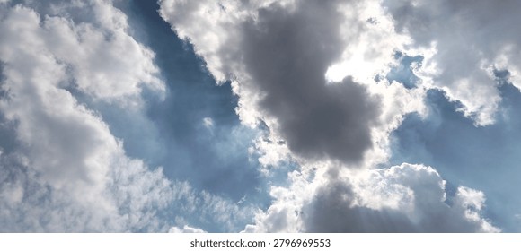 
White clouds block the sun's rays in the blue sky