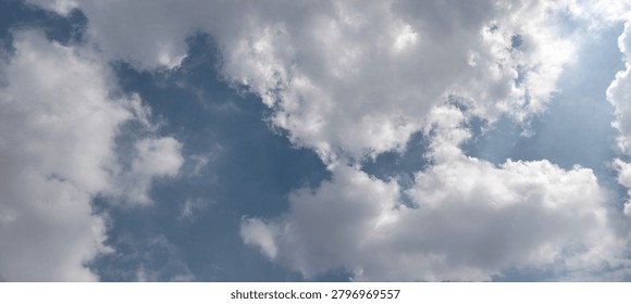 
White clouds block the sun's rays in the blue sky