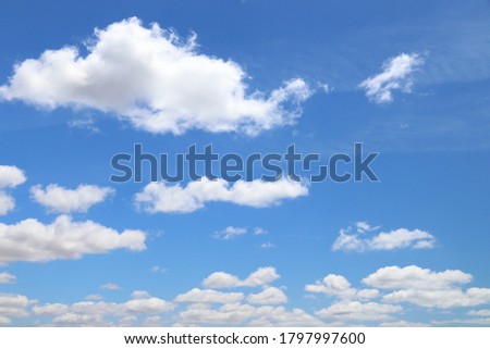 White clouds blue sky background. White fluffly clouds texture.