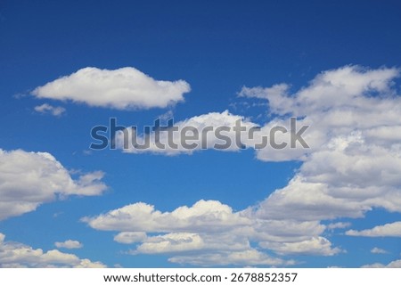 White clouds blue sky background. White fluffly clouds texture.