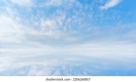 White clouds in the blue sky over a water. Reflection of white clouds and blue sky clouds in the water. Atmospheric natural background. - Powered by Shutterstock