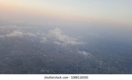 White clouds float over city buildings.