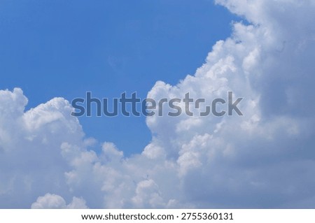 White clouds floating across a clear blue sky