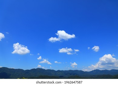 White Clouds Floating In Blue Sky, Rolling Green Hills, Pretty Scenery Of Nature