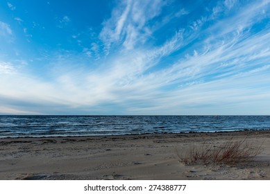 White clouds on the blue sky over country beach