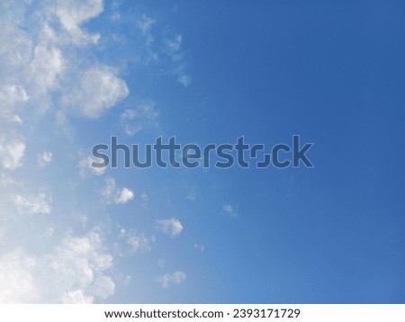 White clouds on the blue sky. The beauty of nature attracts the moods of the environment. The blue background has white cotton balls as the cloudscape weather. Nature makes the idealistic weather.